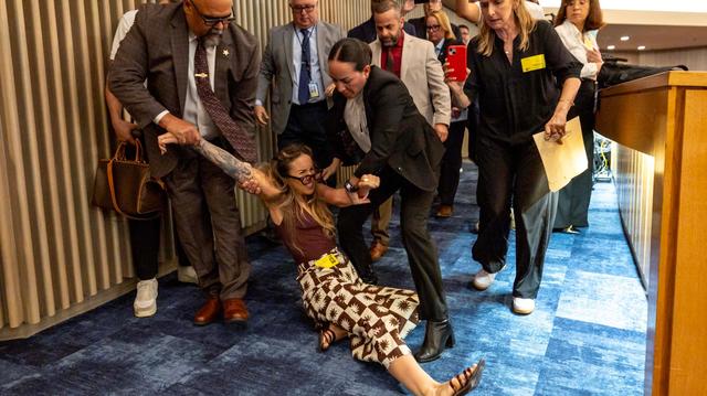 Camila Ramos was removed from the chambers by officers during a Miami-Dade County Commission meeting at the Stephen P. Clark Government Center on Thursday, June 26, 2025. Nine months later, prosecutors dropped the charges against her. 
