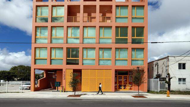 Project Peach, an innovative but compact new building in Overtown that combines design flair with three affordable apartments, offices, a retail space on a tiny substandard lot. It's an intense peach/salmon color that recalls a popular peach soda once produced in overtown by a black-owned company. The building, which recently opened, also includes community space where the developer is planning an exhibit of Overtown photos in Miami, Florida, on Tuesday, March 3, 2026. Project Peach building is located at 123 NW 14th Street, in the Overtown area of Miami.