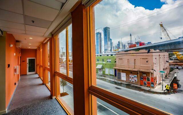 A hallway view inside Project Peach, an innovative but compact new building in Overtown that combines design flair with three affordable apartments, offices, a retail space on a tiny substandard lot. It's an intense peach/salmon color that recalls a popular peach soda once produced in overtown by a black-owned company. The building, which recently opened, also includes community space where the developer is planning an exhibit of Overtown photos in Miami, Florida, on Tuesday, March 3, 2026. Project Peach building is located at 123 NW 14th Street, in the Overtown area of Miami.