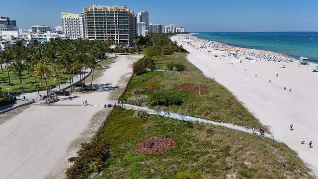 As part of Miami Beach's crackdown on homelessness, police have flown drones to locate people and their belongings hidden in the dune area along the beach. Since last year, officers have conducted more than 40 drone flights that located 80 homeless "encampments" and resulted in eight arrests, according to city officials.In the evenings, access to the beach is restricted on Miami Beach, Florida, on Tuesday, March 24, 2026.