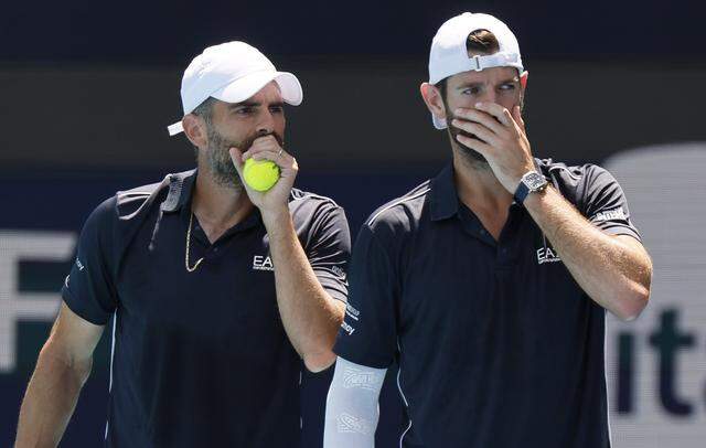 Italy's Simone Bolelli and Andrea Vavassori cover their mouths as the talk to each other during doubles match against Harri Heliovarra of Finland and Henry Patten of Great Britain in the stadium during the Miami Open in Miami Gardens, Florida, on Saturday, March 28, 2026.