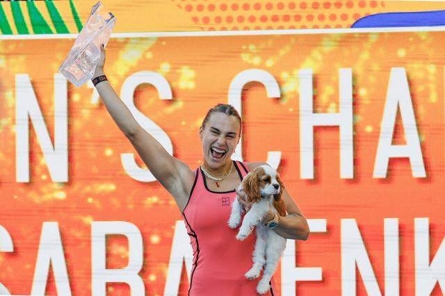 Aryna Sabalenka holds her dog Ash as she lifts the Butch Buchholz trophy after defeating Coco Gauff during the women's singles title during the Miami Open at Hard Rock Stadium in Miami Gardens, Florida, on Saturday, March 28, 2026.