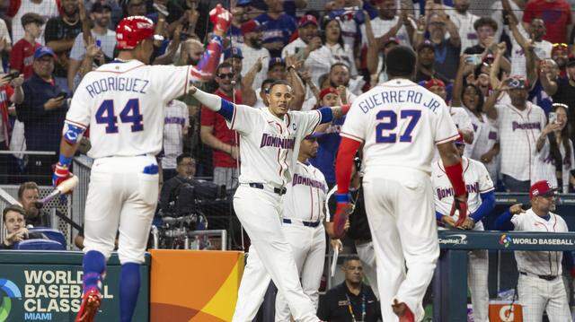 Dominican Republic first baseman Vladimir Guerrero Jr. (27) celebrates with his teammates after scoring a run against Korea in the second inning of their World Baseball Classic quarterfinal game at loanDepot park on Friday, March 13, 2026, in Miami, Fla.