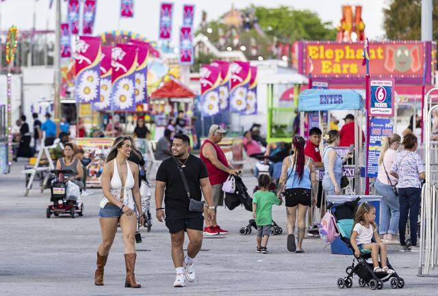 Guests make their way through the fairgrounds during the opening day of the 74th annual Miami-Dade County Youth Fair on Thursday, March 12, 2026, in Miami, Fla.