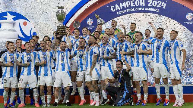 In this file photo, the Argentina team holds the trophy after defeating Colombia in their Copa America 2024 Final soccer match at Hard Rock Stadium on Sunday, July 14, 2024, in Miami Gardens.
