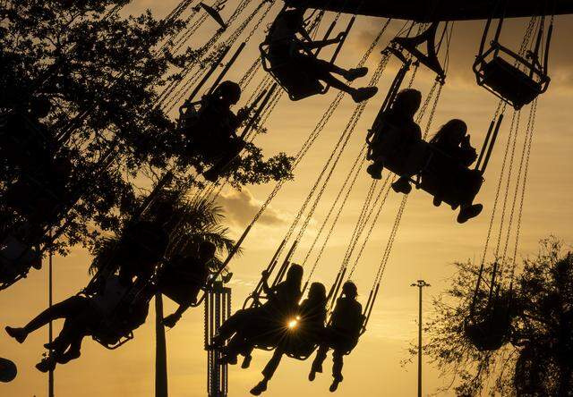Guest ride on a swing attraction during the opening day of the 74th annual Miami-Dade County Youth Fair on Thursday, March 12, 2026, in Miami, Fla.