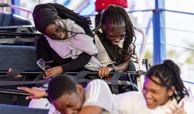 Melanie, left, and Alyai react as they ride an attraction during the opening day of the 74th annual Miami-Dade County Youth Fair on Thursday, March 12, 2026, in Miami, Fla.