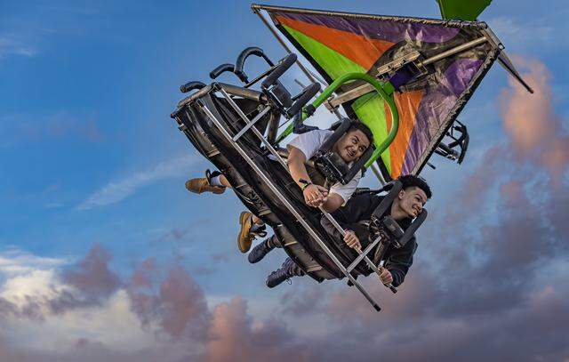 Samson Lee, left, and Anthony Acevedo, ride the Cliff Hanger attraction during the opening day of the 74th annual Miami-Dade County Youth Fair on Thursday, March 12, 2026, in Miami, Fla.