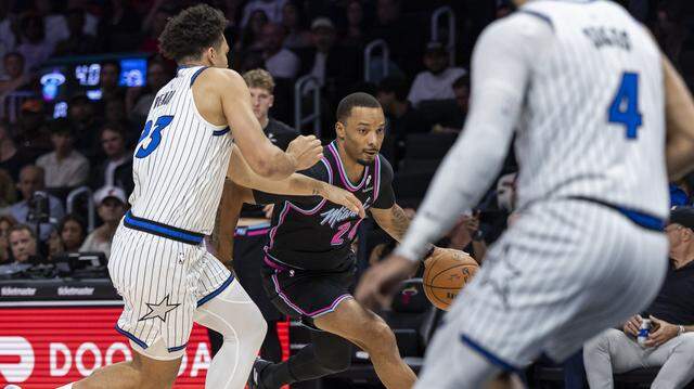 Miami Heat guard Norman Powell (24) drives the ball as Orlando Magic forward Noah Penda (93) defends in the first half of their NBA game at the Kaseya Center on Saturday, March 14, 2026, in downtown Miami, Fla.