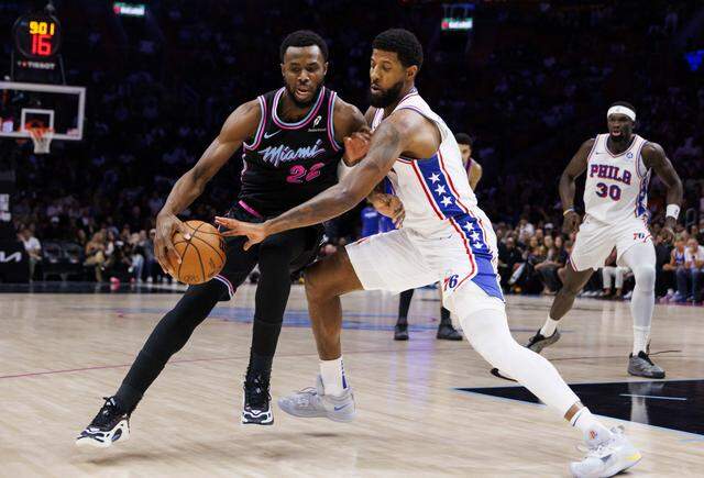 Miami Heat forward Andrew Wiggins (22) tries to keep the ball from Philadelphia 76ers forward Paul George (8) during the first half of a game on Monday, March 30, 2026, at the Kaseya Center in downtown Miami, Fla. 