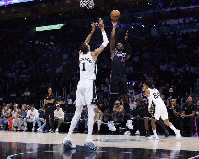 Miami Heat center Bam Adebayo (13) shots over San Antonio Spurs forward Victor Wembanyama (1) during the first half of the game on Monday, March 23, 2026, at the Kaseya Center in downtown Miami, Fla.
