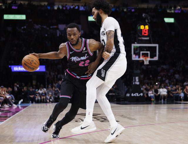 Miami Heat forward Andrew Wiggins (22) dribbles against San Antonio Spurs forward Julian Champagnie (30) during the first half of the game on Monday, March 23, 2026, at the Kaseya Center in downtown Miami, Fla. 