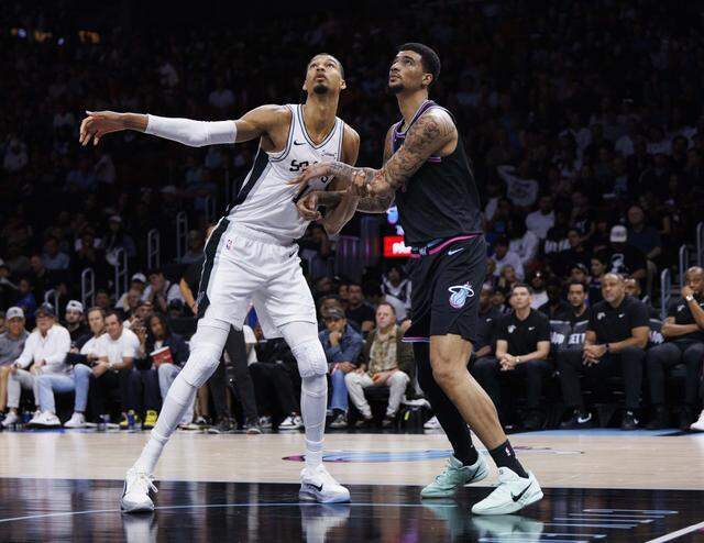 Miami Heat center Kel'el Ware (7) boxes out San Antonio Spurs forward Victor Wembanyama (1) during the second half of the game on Monday, March 23, 2026, at the Kaseya Center in downtown Miami, Fla. 