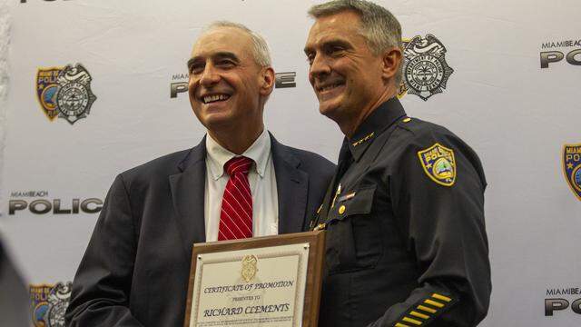 Former Miami Beach Police Chief Dan Oates, left, poses with incoming chief Rick Clements at Miami Beach City Hall on July 1, 2019.