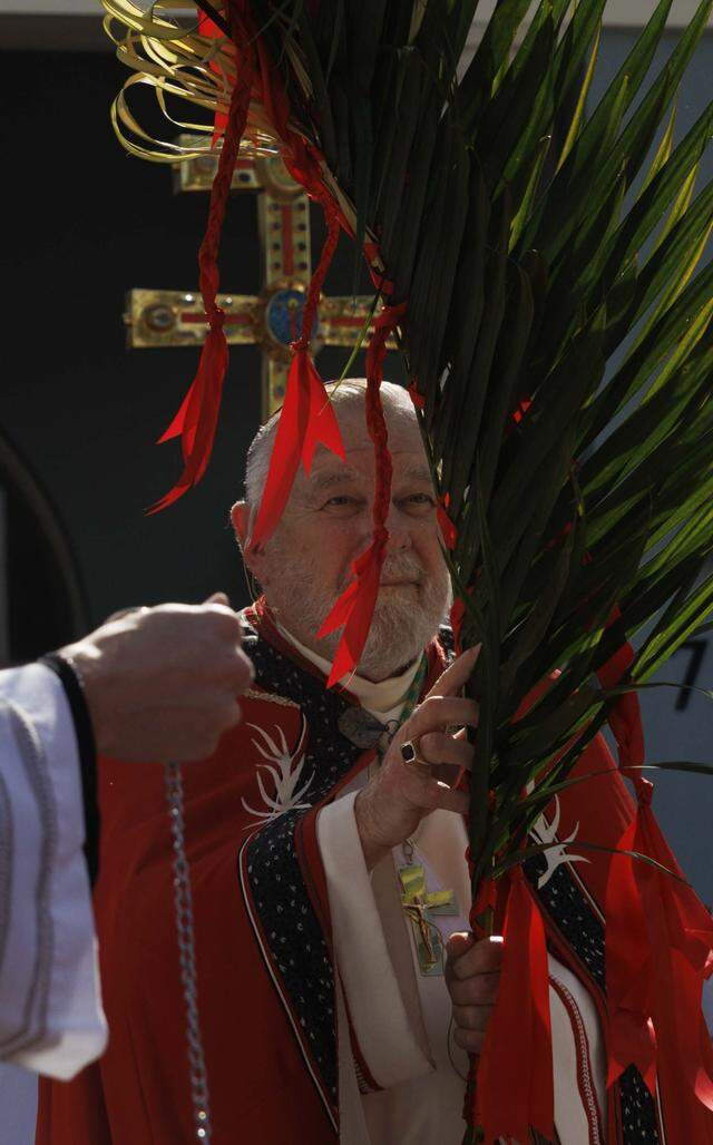 Archbishop Thomas Wenski holds palms he blessed before Palm Sunday Mass on Sunday, March 29, 2026, at the Cathedral of St. Mary in Miami, Fla. The service began with the traditional blessing of the palms outside the cathedral followed by Mass.