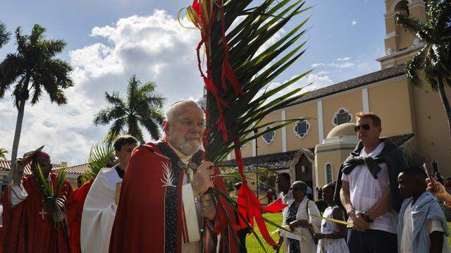 Archbishop Thomas Wenski, center, processes past the crowd towards the cathedral after the traditional blessing of the palms before Palm Sunday Mass on Sunday, March 29, 2026, at the Cathedral of St. Mary in Miami, Fla. “It is easy for us to say we would’ve done something different than the crowd or Pontius Pilate, but when we are silent in the face of suffering in the world around us [we are complacent],” said the Archbishop in his homily at mass.