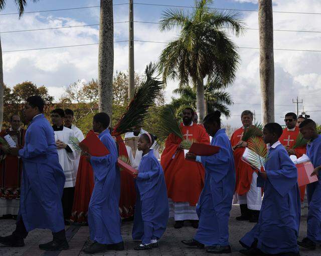 The children choir processes into mass following the traditional blessing of the palms before Palm Sunday Mass on Sunday, March 29, 2026, at the Cathedral of St. Mary in Miami, Fla.