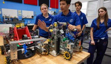 Reece Liu, a 10th grader and member of the Cyber Spartans robotics team, discusses the robot the team will enter in the Florida state championship during a presentation at the Garner Center for Innovation at Miami Country Day School at 601 NE 107th St., on Monday, March 2, 2026, in Miami. Fla. Liu is joined by team captain Cameron Schoch, left, team member Martin Parker Sierra, and team member Maia Mandel, right.