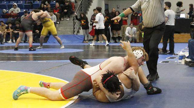 Michael Mocco of Cardinal Gibbons HS (top) wrestlers Lamon Witherspoon of Miramar HS in the 285-pound championship match at the BCAA Wrestling Championships on Saturday, February 7, 2026 at Dillard HS in Fort Lauderdale. P. Mocco won the match. Andrew Uloza / for Miami Herald