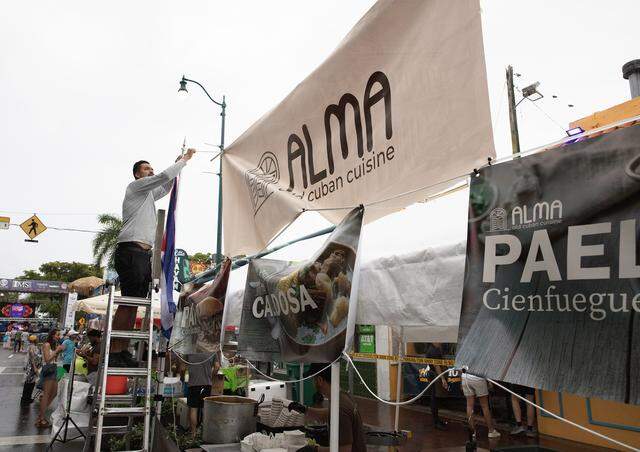A vendor prepares his tent for the Calle Ocho festival on Sunday, March 15, 2026 in Little Havana. Andrew Uloza / for Miami Herald