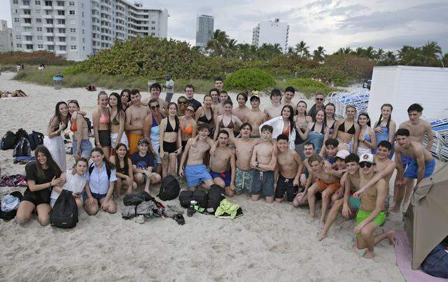 Middle school students of College Emmanuel D’alzon, from Nimes, France, pose for a picture in South Beach while traveling accros Florida on Saturday, March 14, 2026.