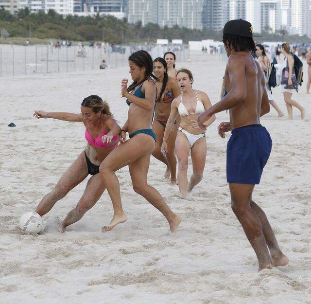 Young people play soccer on the beach during spring break weekend, March 14, 2026 in Miami Beach. 
