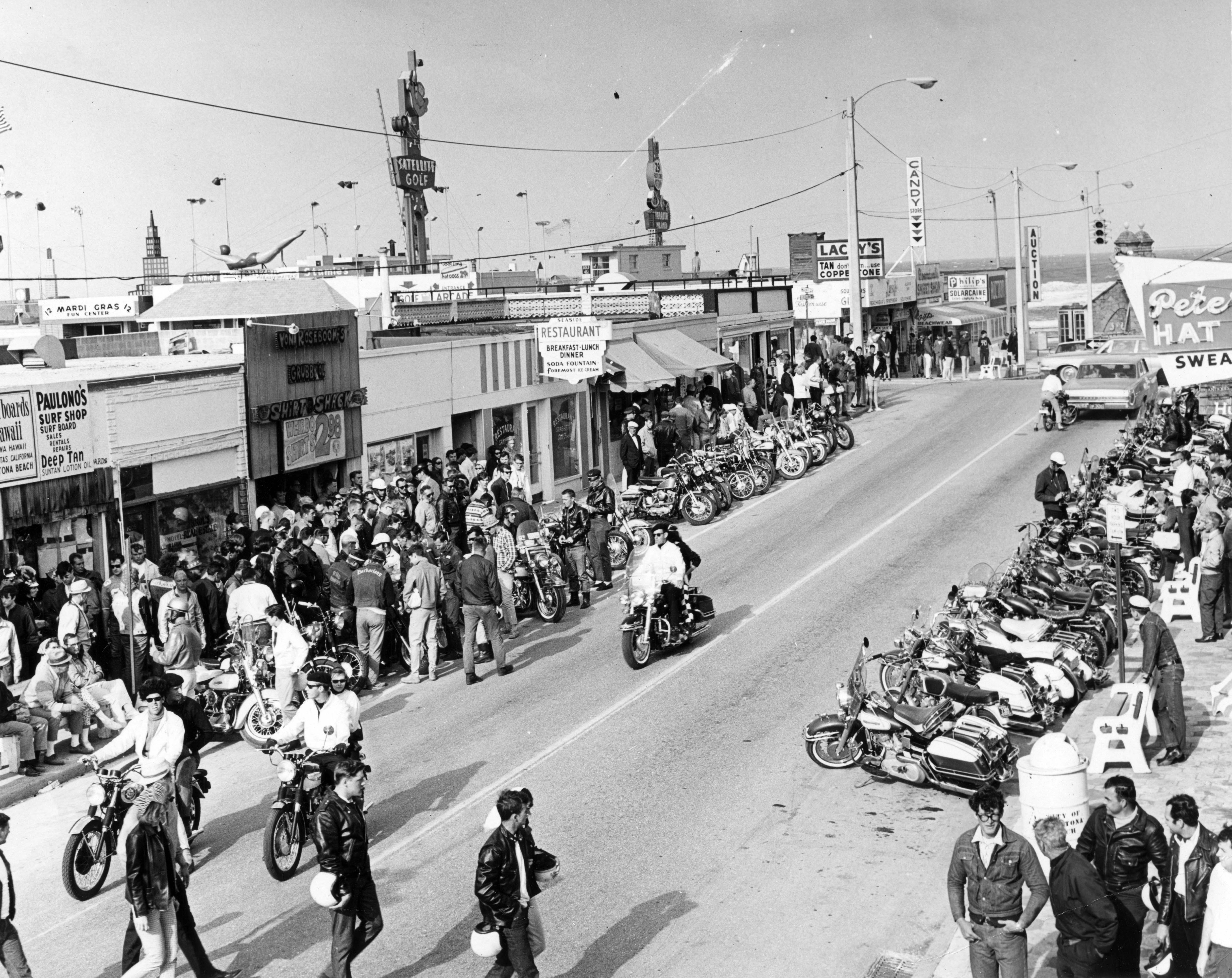 Bikers and other visitors gather along Main St. in Daytona...