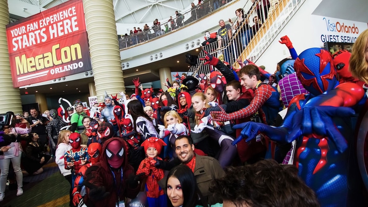 Guests dressed as Spider-Man universe characters meet for a photo opportunity at Megacon.