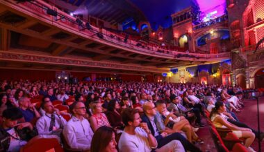 photo of a packed theater bathed in purple lighting during the Miami Film Festival