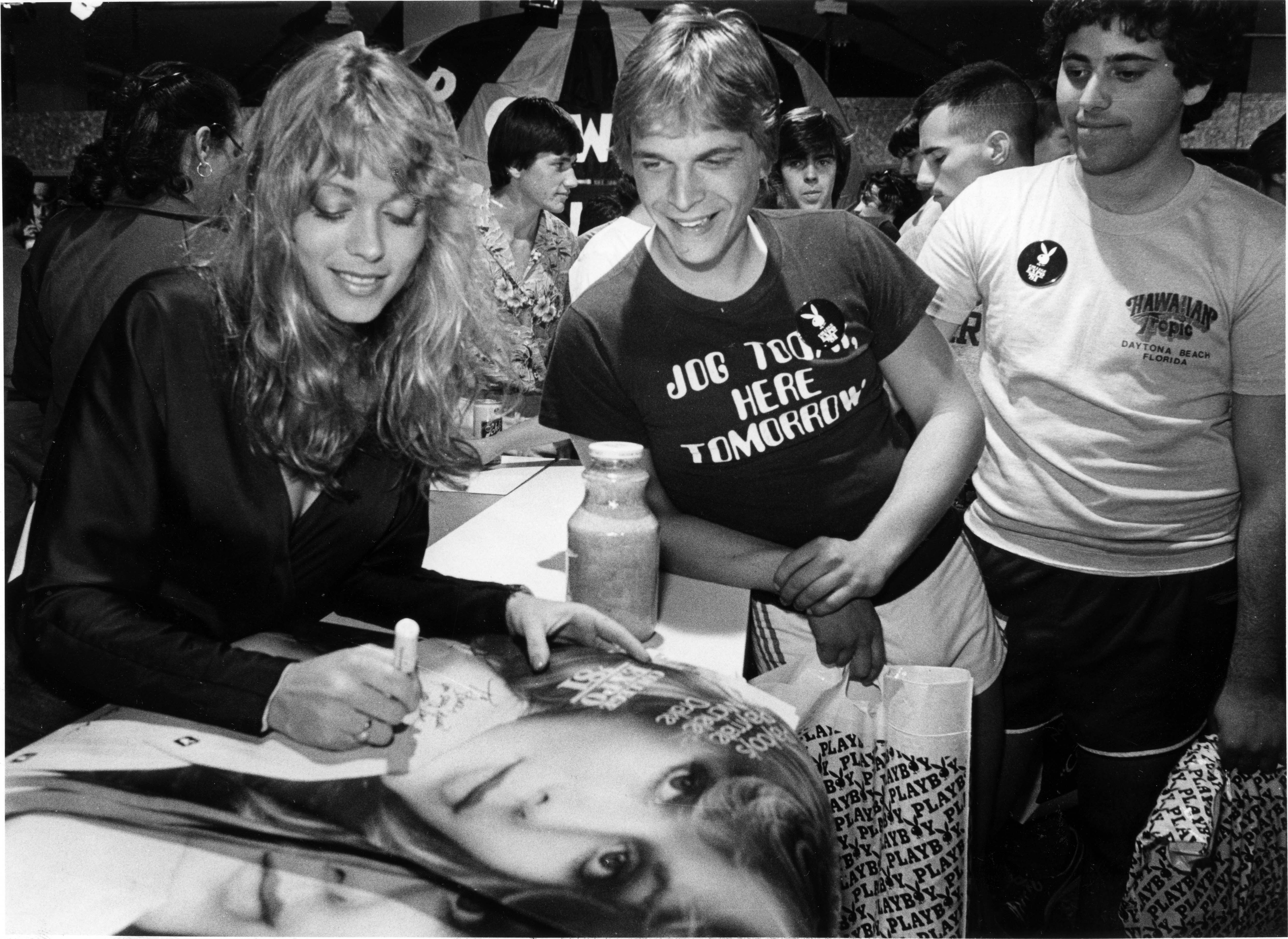 Playboy Playmate, Michele Deake, autographs a photo for Steve Kaplan...