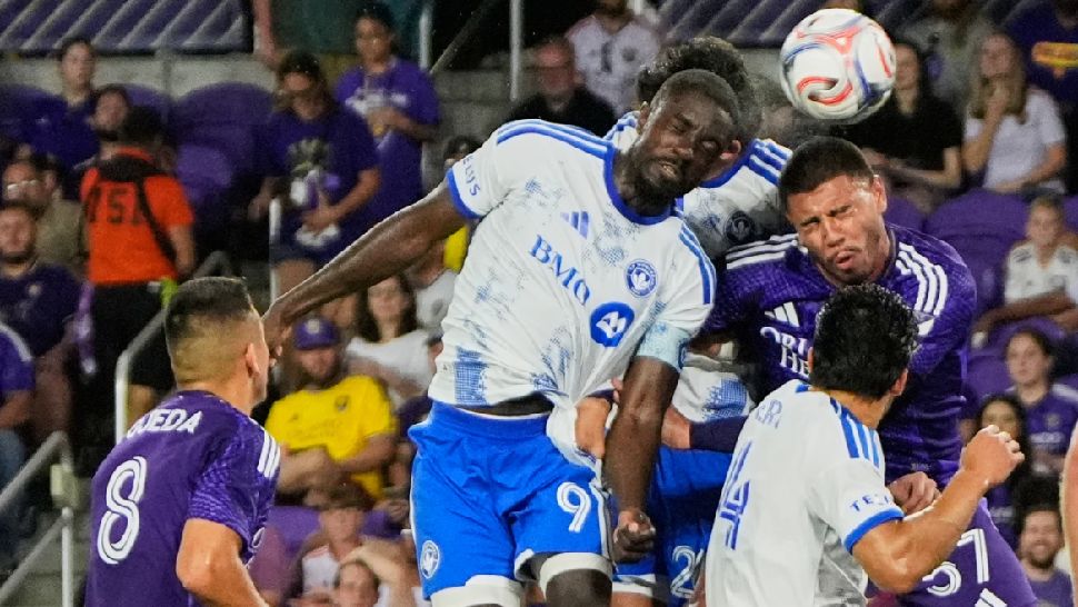 CF Montreal forward Prince Owusu (9) heads the ball to score a goal off a corner kick against Orlando City defender Iago during the first half of an MLS soccer match, Saturday, March 14, 2026, in Orlando, Fla. (AP Photo/John Raoux)