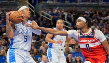 Orlando Magic forward Paolo Banchero (5) grabs a rebound in front of Washington Wizards guard Bilal Coulibaly (0) during the first half of an NBA basketball game, Thursday, March 12, 2026, in Orlando, Fla. (AP Photo/John Raoux)