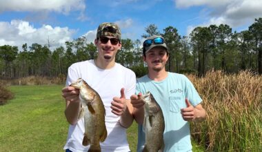 Fishermen from Kentucky hold a couple of barramundi fish caught is St. Cloud.  It's one of the only fishing holes in North America where anglers can catch the fish, which is native to Australia. (Spectrum News/Randy Rauch)