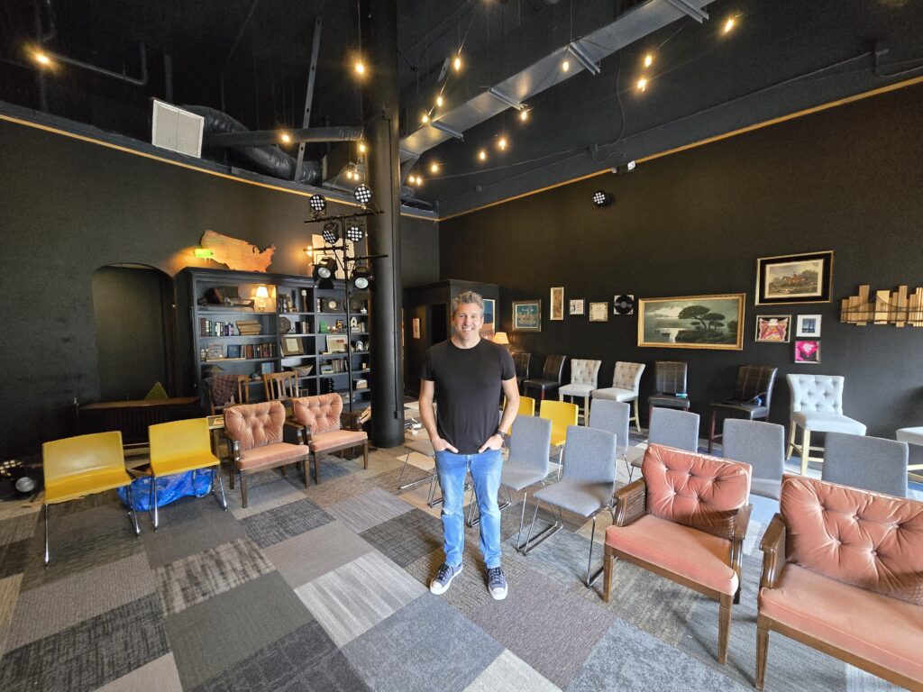 a man stands in a black box theater