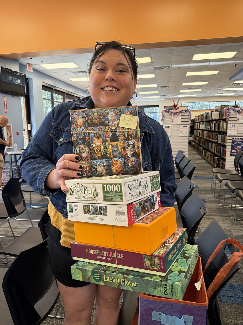Winter Garden’s Jojo Monetti walked away with several puzzles from the puzzle exchange at West Oaks Branch Library. She participated in the swap for the first time and said she loved finding a puzzle community.
