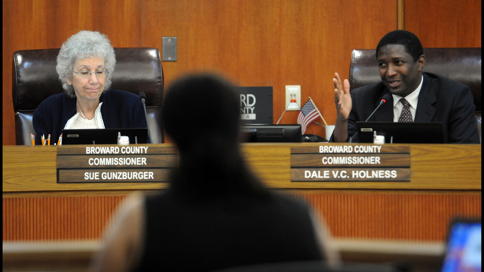 Broward County (right) Dale V.C. Holness speaks as Commissioner Sue...