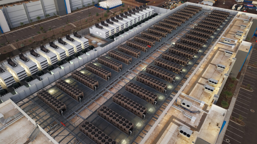 Cooling towers and backup generators on the roof of a data center (Rsparks3, CC0, via Wikimedia Commons)