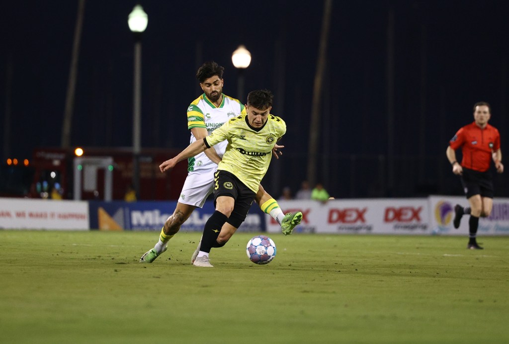 The Pittsburgh Riverhounds' Danny Griffin is pressured on the ball by the Tampa Bay Rowdies' Marco Micaletto in the team's match March 21, 2026 at Al Lang Stadium in St. Petersburg, Fla. (Photo: Tampa Bay Rowdies)