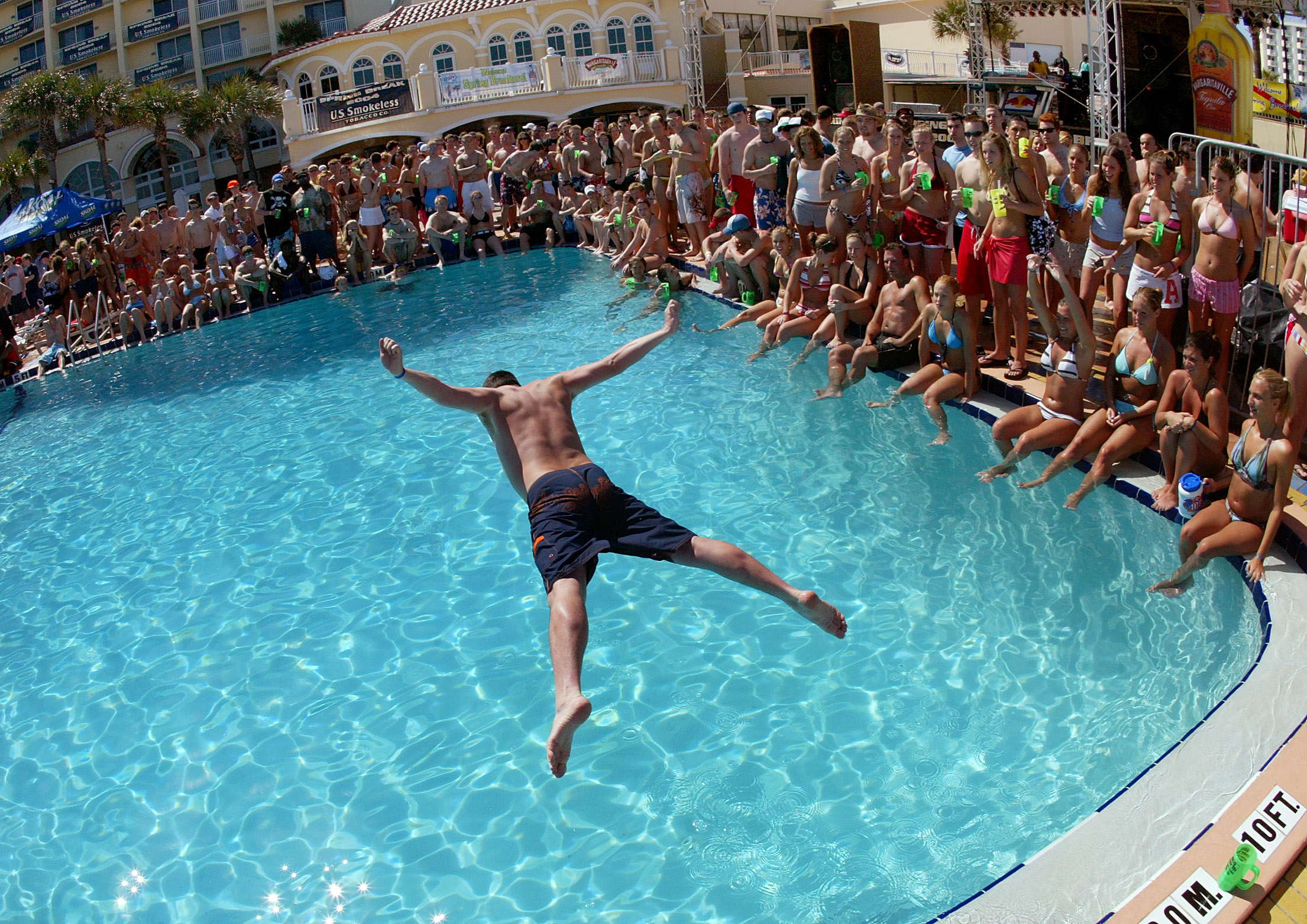 With the pool ringed by fellow spring breakers a belly...