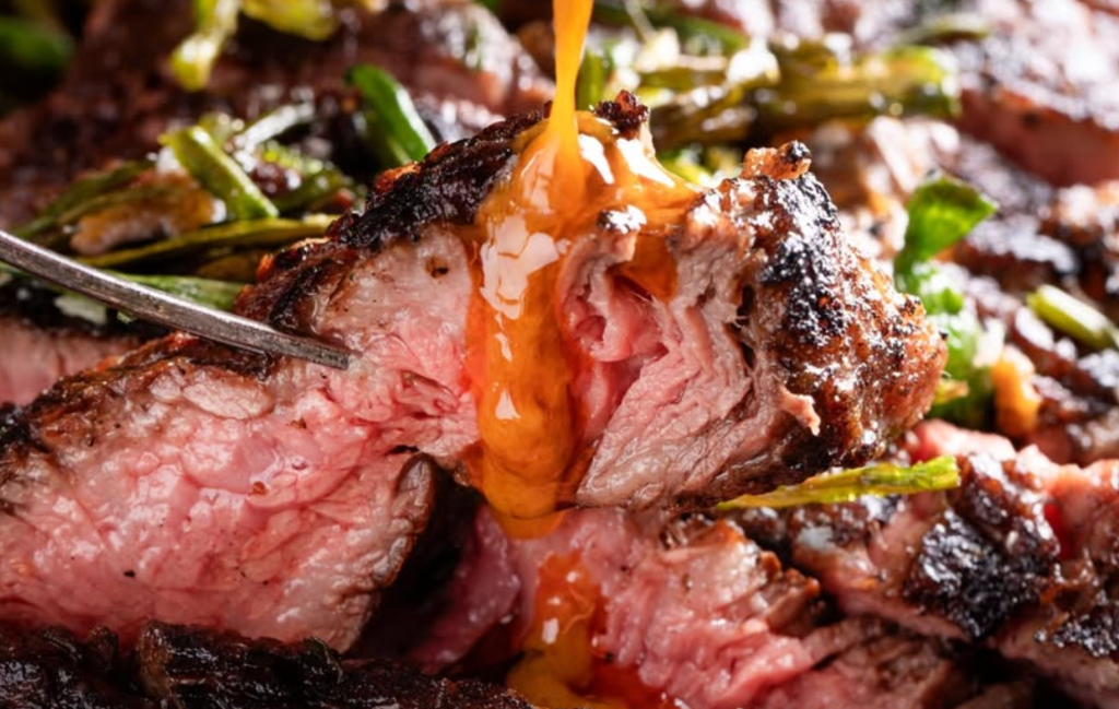 a juicy piece of steak with toppings and sauce