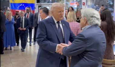 President Donald Trump shaking hands at a restaurant in Doral