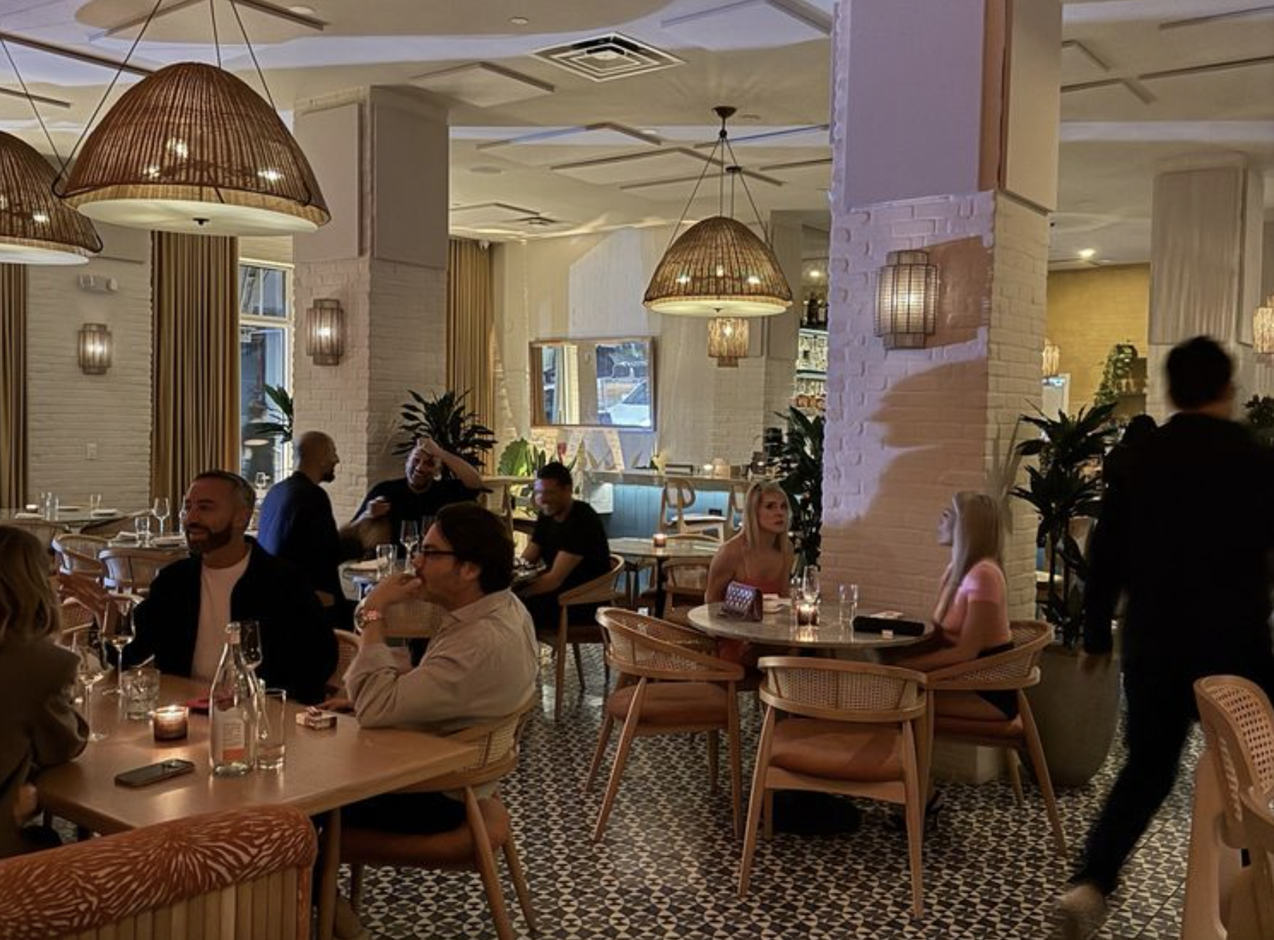 a dining room with tables and a few scattered guests