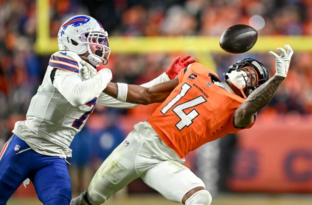 Courtland Sutton (14) of the Denver Broncos draws a key pass interference call on Taron Johnson (7) of the Buffalo Bills during overtime of the Broncos' 33-30 win at Empower Field at Mile High in Denver, Colorado on Saturday, Jan. 17, 2026. (Photo by AAron Ontiveroz/The Denver Post)