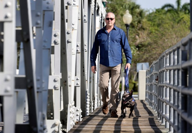 Michael Rajner walks his dog, Blue, in Fort Lauderdale on Thursday, March 19, 2026. Blue accompanied Rajner to Tallahassee almost every week during the legislative session. (Carline Jean/South Florida Sun Sentinel)