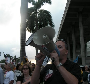 Activist Michael Rajner, holding two bullhorns, at a demonstration outside the Federal Courthouse in Fort Lauderdale in March 2011. (Anthony Man/South Florida Sun Sentinel)