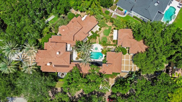 An aerial view of the estate at 1400 Alabama Drive in Winter Park shows the lush landscaping that surrounds the .72 acre corner lot. Across from the house is a private covered boat dock on Lake Maitland while across the street it the historic Kraft Azalea Garden. (Image provided by Rachel Peters)
