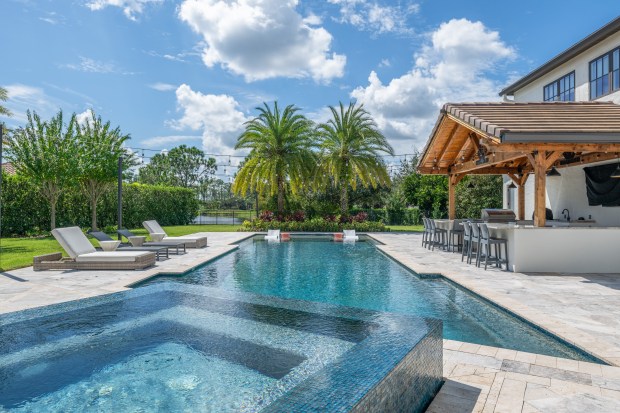 The corner lot in the gated Keene's Pointe golf community sits on .85 acres and overlooks a pond. (Photo by VTR Image)