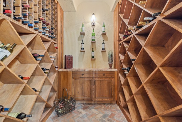 The spacious wine cellar has ample storage for entertaining. (Photo by Michael Pelzer / Uneek Luxury)