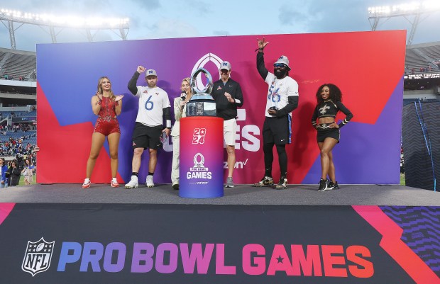 NFC Tampa quarterback Baker Mayfield (6) and NFC New Orleans linebacker Demario Davis (56) and NFC head coach Eli Manning (middle) celebrate after winning the NFL Pro Bowl game at Camping World Stadium in Orlando on Sunday, February 4, 2024. (Stephen M. Dowell/Orlando Sentinel)