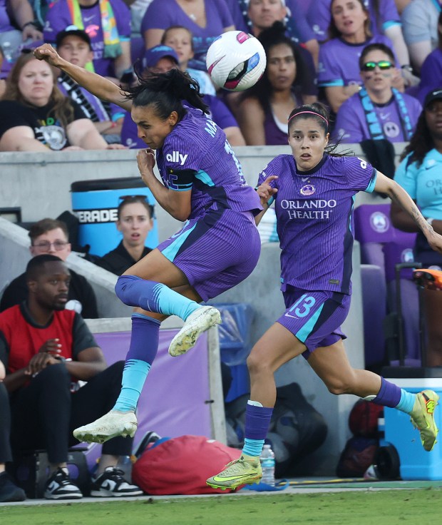 Orlando player Marta (left) leaps to control the ball in front of teammate jacqueline Ovalle (13) during the NWSL semifinal playoff match of Gotham FC at Orlando Pride at Inter&Co Stadium in Orlando on Sunday, November 16, 2025. Gotham FC won the game 1-0. (Stephen M. Dowell/Orlando Sentinel)